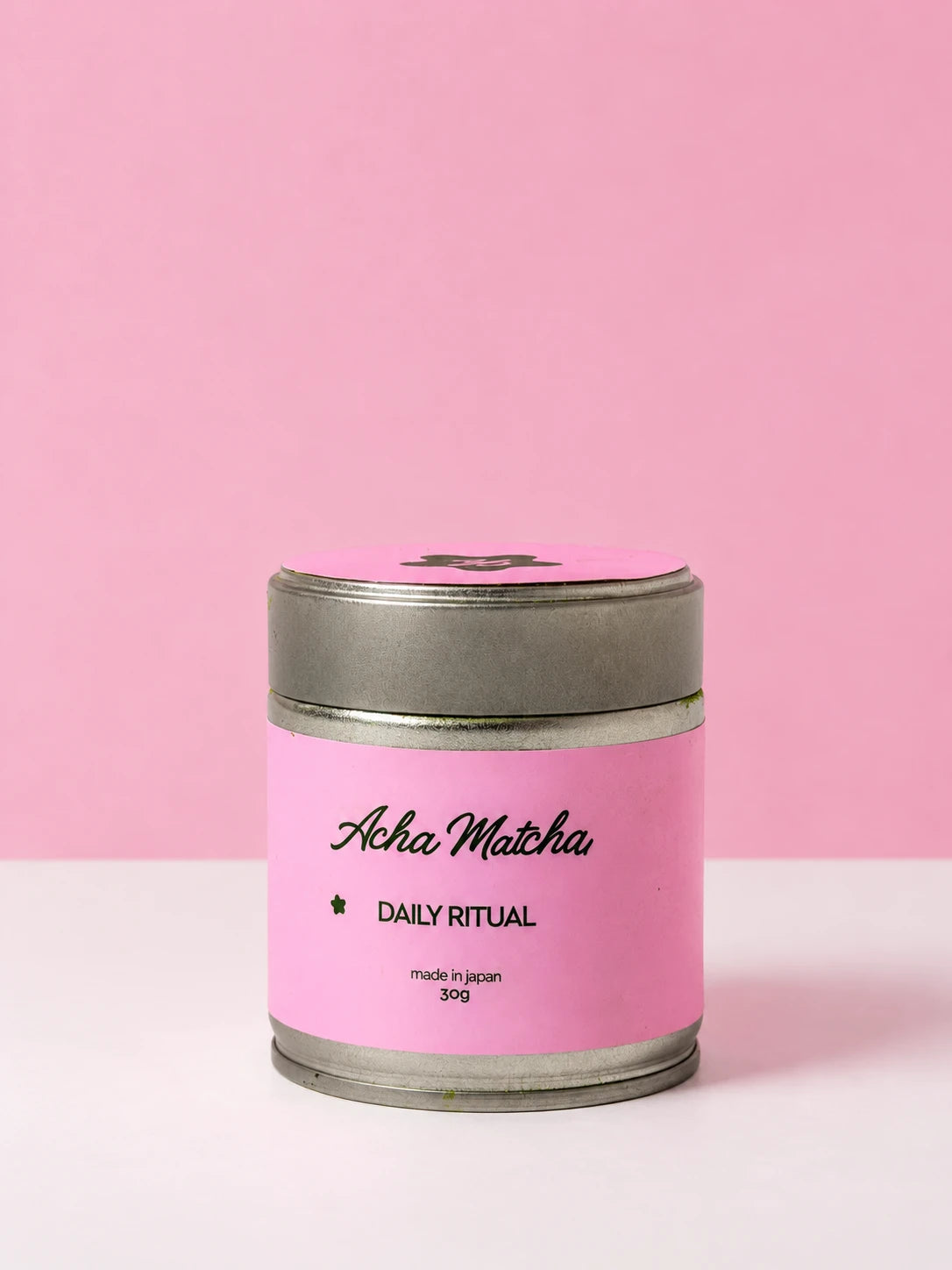 Daily Ritual: Acha Matcha 30g tin on a pink studio background