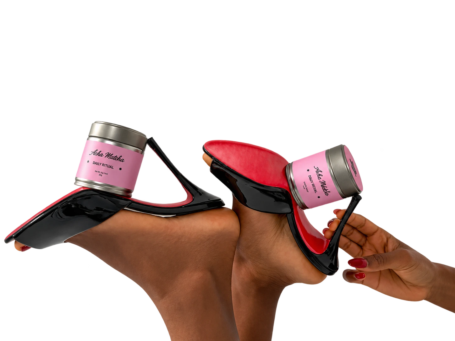 Pink matcha tins balanced on black heels during the Acha Matcha shoot