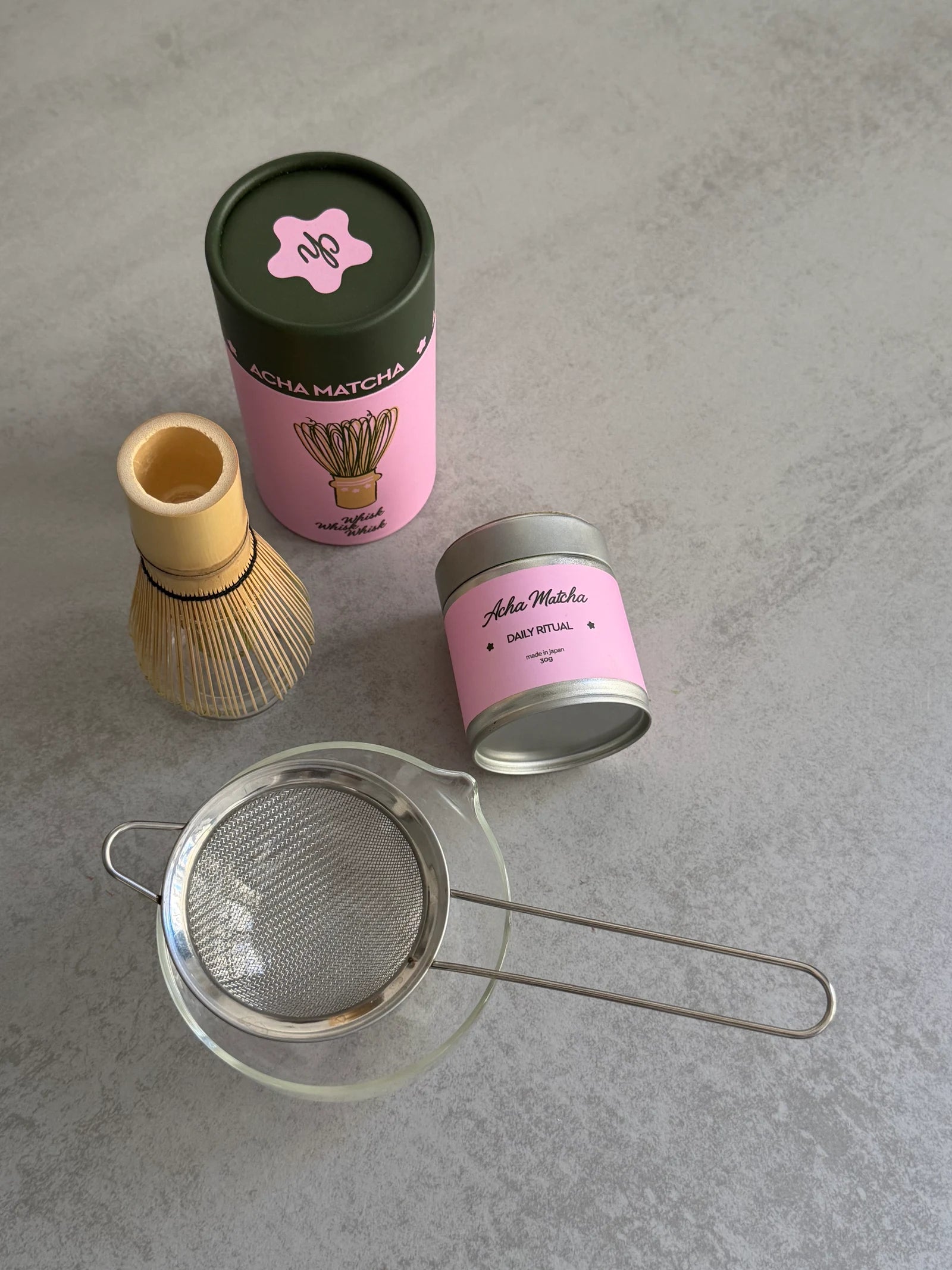 Matcha tin, bamboo whisk and sieve arranged before preparation