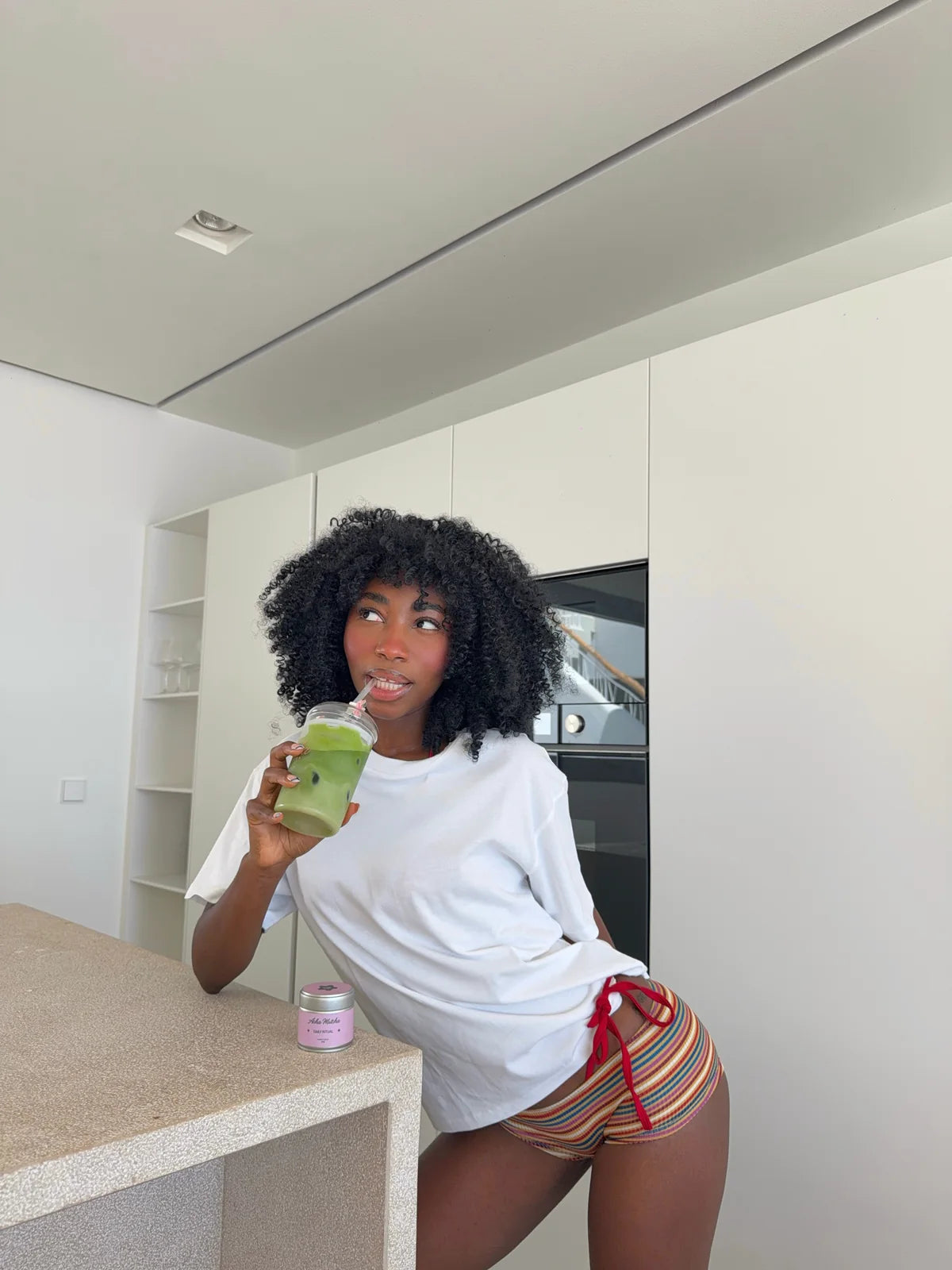 Vanessa Acha holding a matcha at home
