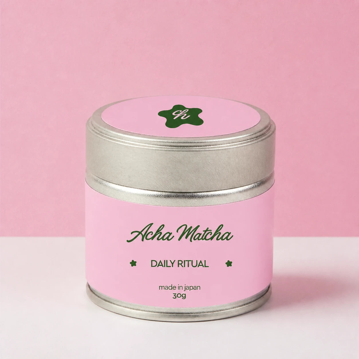 Acha Matcha Daily Ritual tin on a soft pink studio background